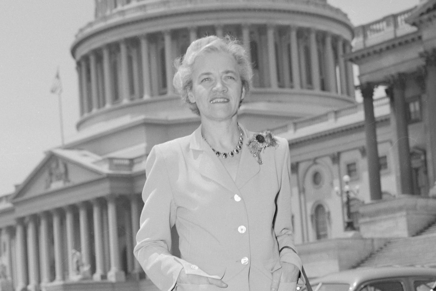 Black and white photo of Margaret Chase Smith standing in front of the Capitol Building